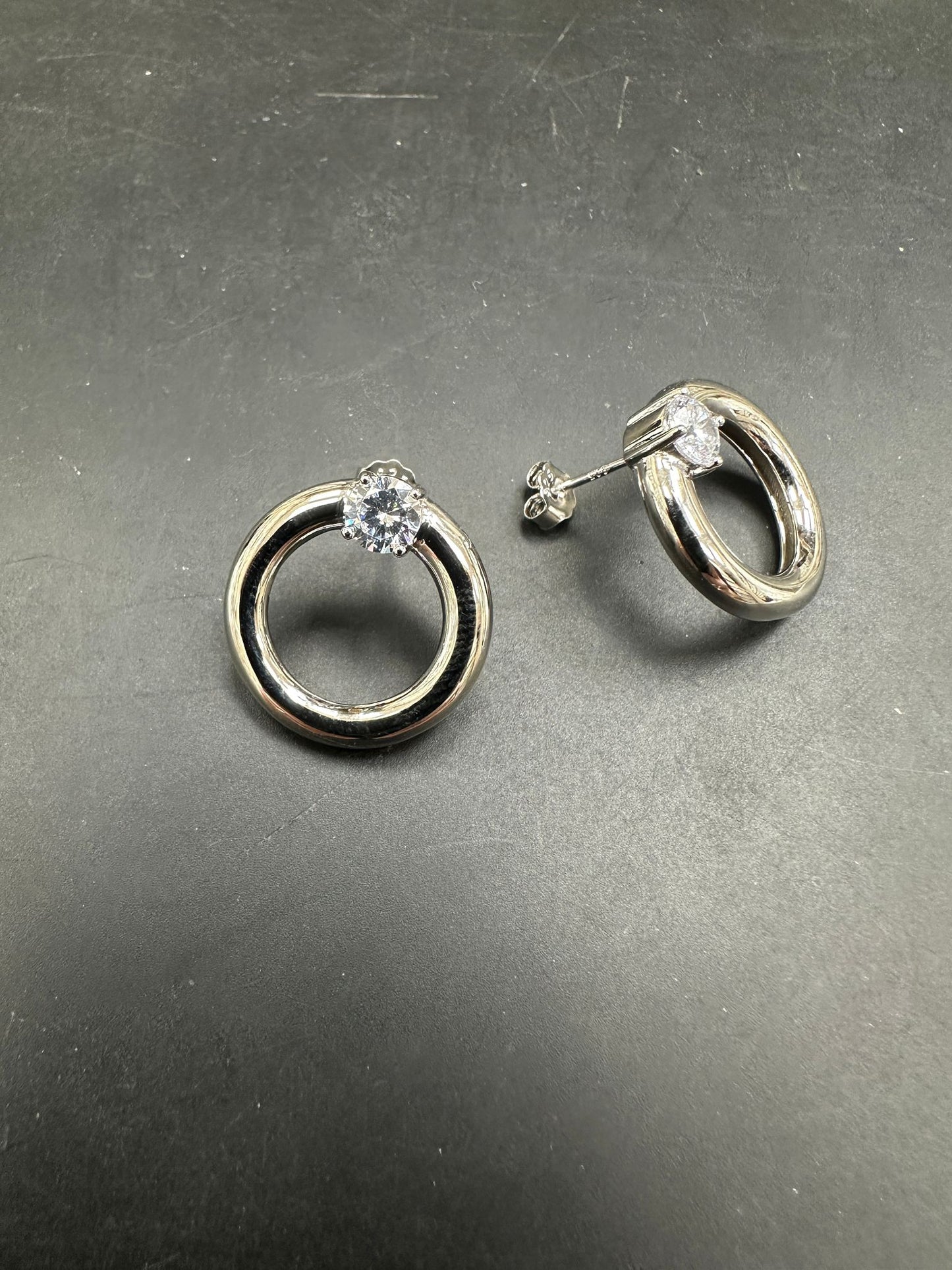 Sterling silver cz stone earrings featuring an elegant design with a sparkling cz stone centerpiece.