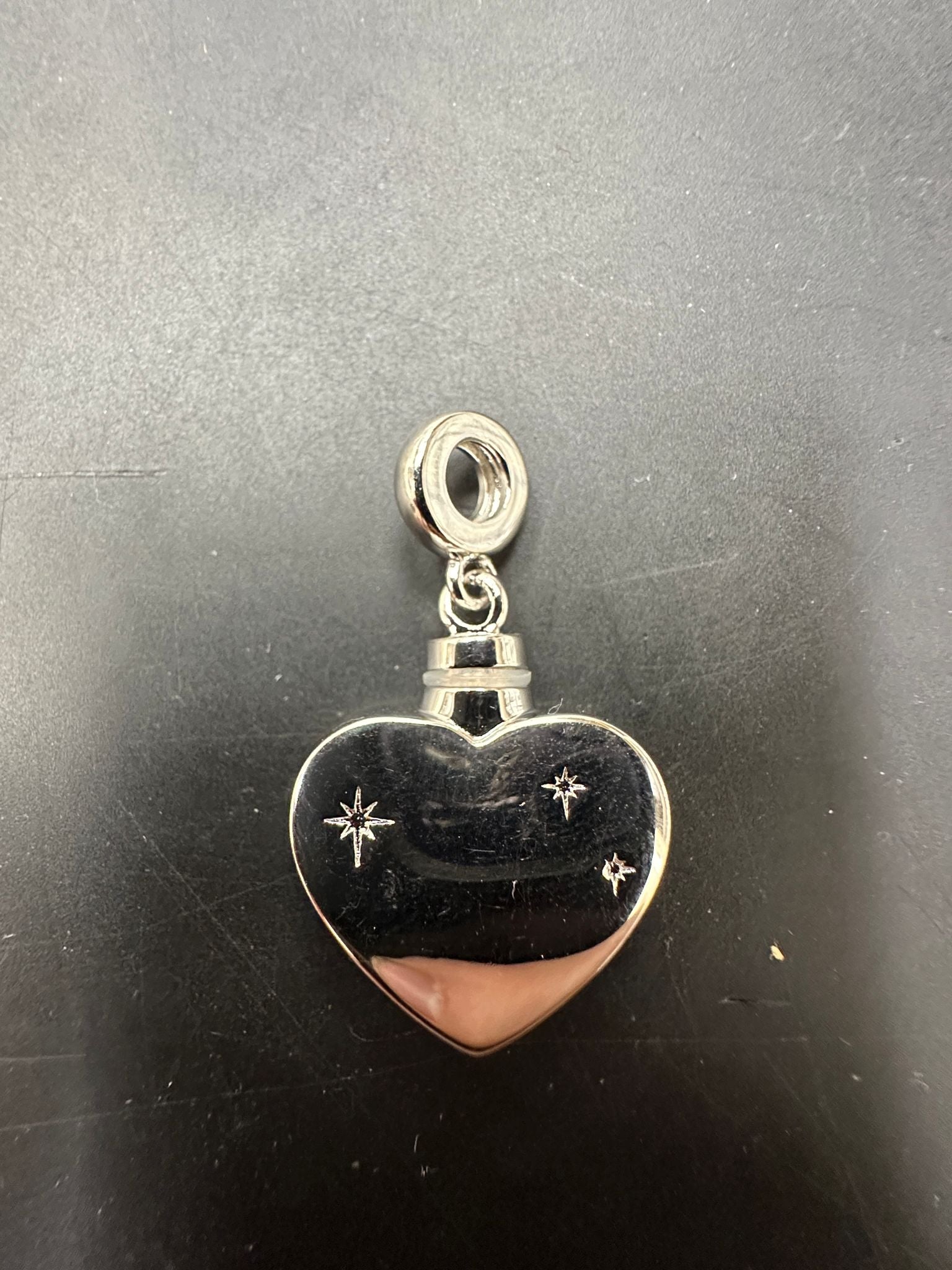 Sterling silver heart pendant with CZ stones, beautifully crafted in a heart shape for elegant jewelry designs.