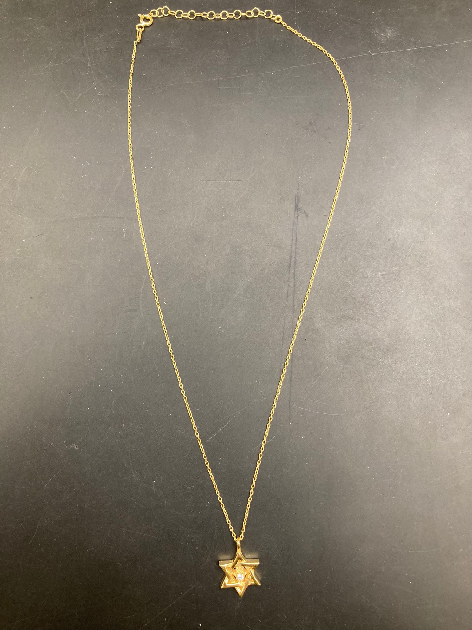 Sterling silver compass necklace NP10208 displayed on a dark surface, showcasing its elegant design.