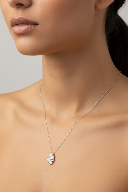 Sterling silver hamsa hand necklace worn by a model, showcasing elegant design and craftsmanship.