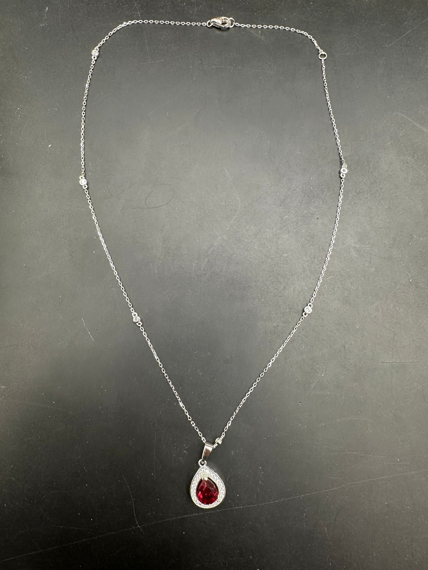 Sterling Silver Cz Pear Shape Necklace NCZ019 showcasing a beautiful pear shape cz necklace with a red pendant.