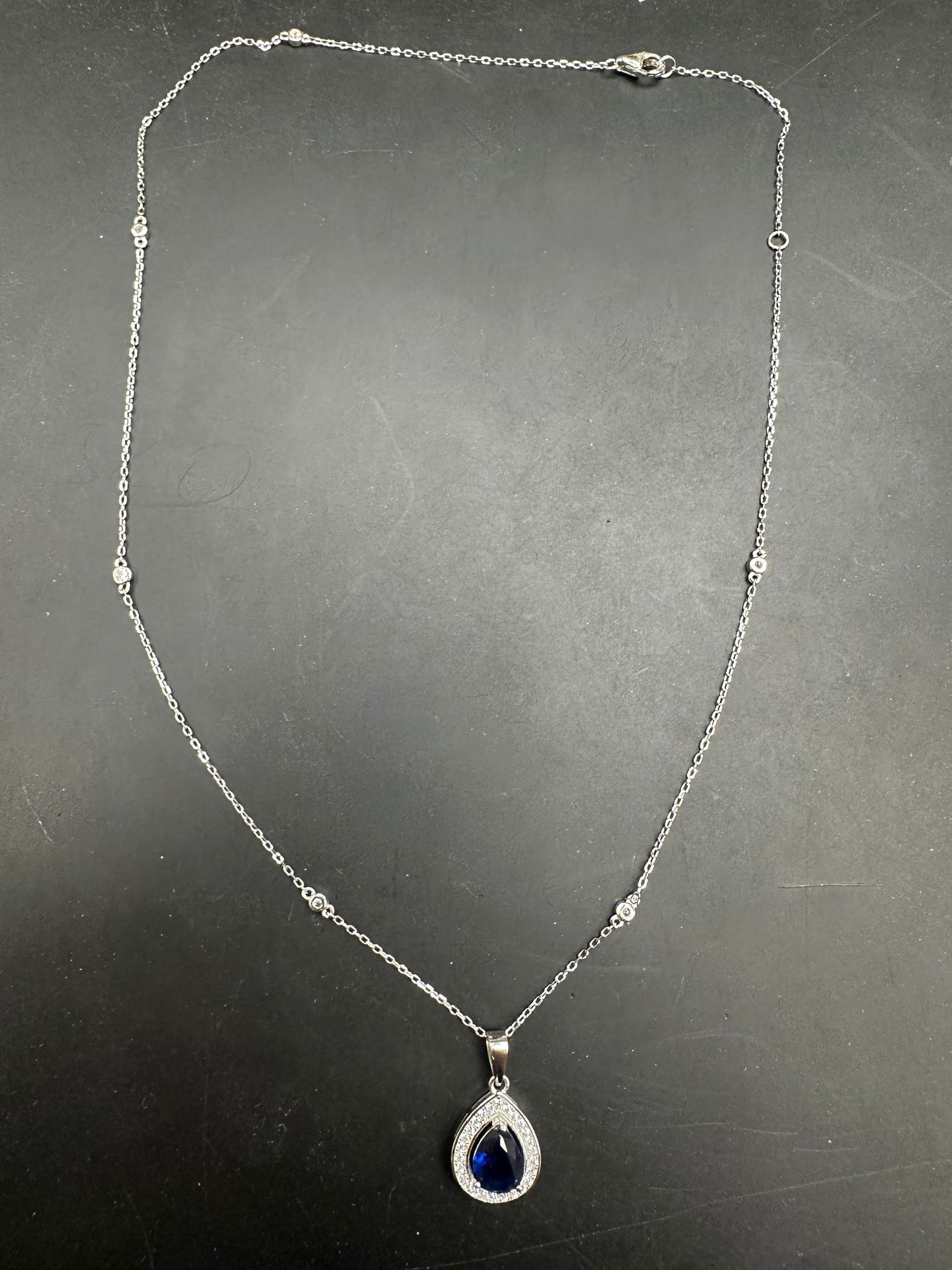 Sterling Silver Cz Pear Shape Necklace NCZ019 featuring a pear shape cz necklace with a blue gemstone pendant.