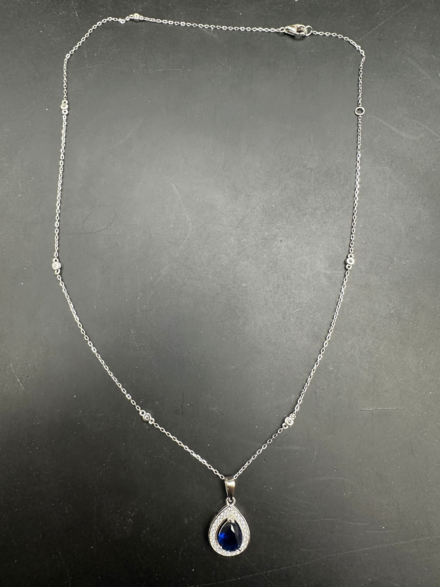 Sterling Silver Cz Pear Shape Necklace NCZ019 featuring a pear shape cz necklace with a blue gemstone pendant.