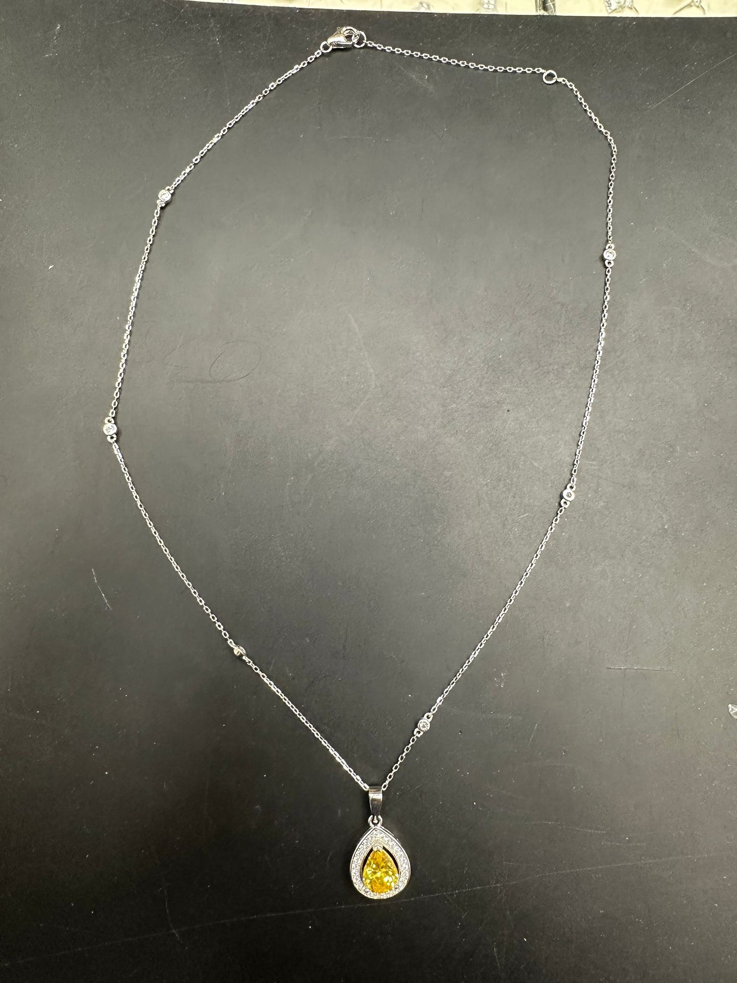 Pear shape cz necklace in sterling silver with a yellow gemstone pendant.