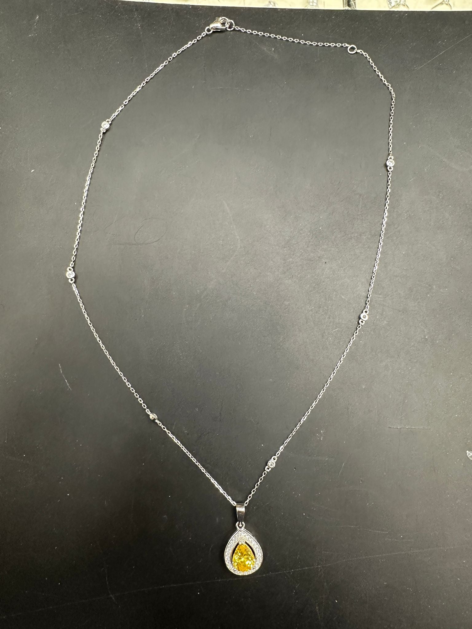 Pear shape cz necklace in sterling silver with a yellow gemstone pendant.