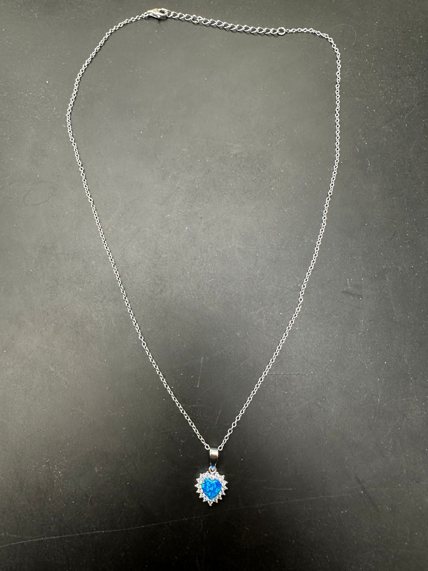 Sterling silver CZ blue opal heart necklace showcasing a vibrant blue opal pendant on a delicate chain.