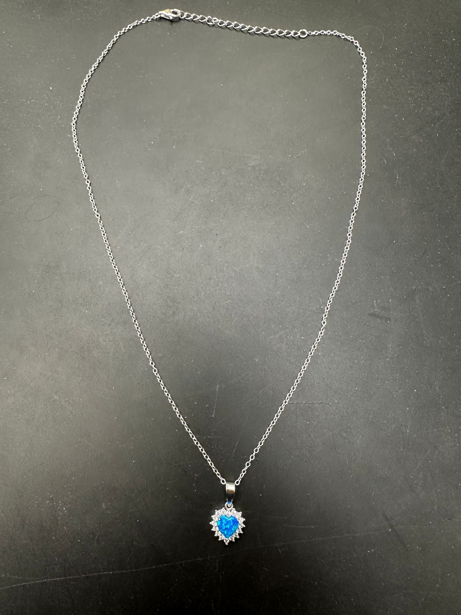 Sterling silver CZ blue opal heart necklace showcasing a vibrant blue opal pendant on a delicate chain.