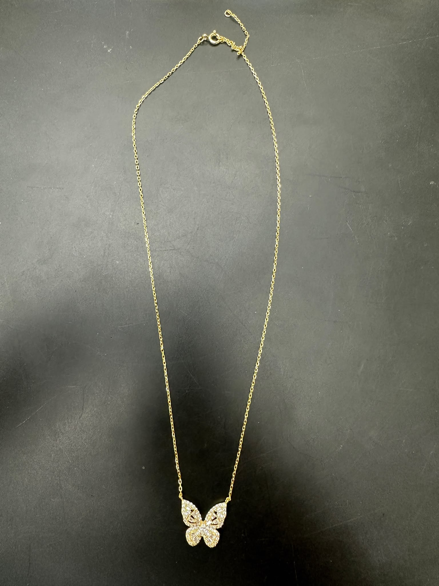 Sterling silver butterfly necklace NCZ1020 with gold plated finish and sparkling details on a dark background.