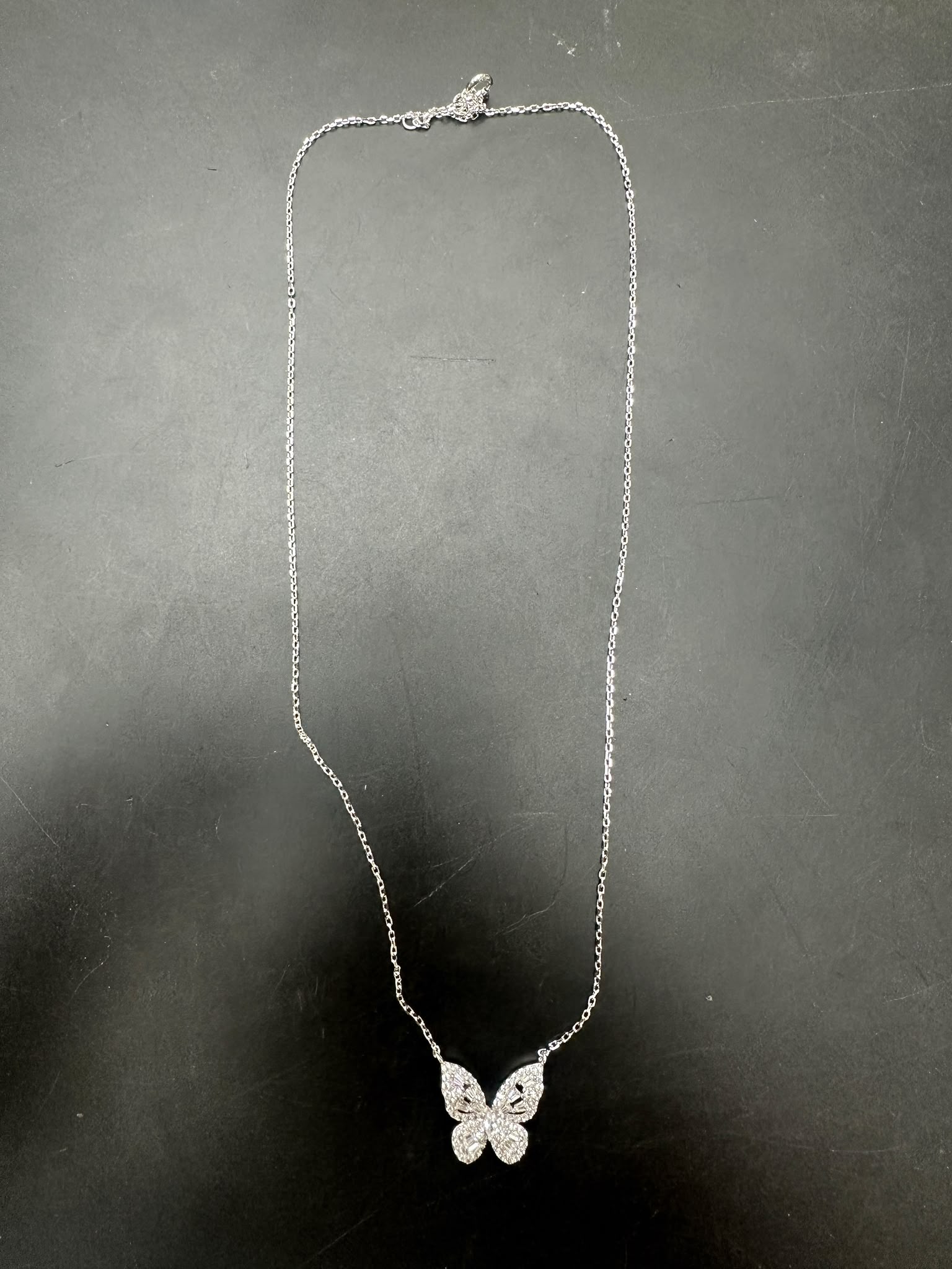 Sterling silver butterfly necklace NCZ1020 showcasing elegant design and charm on a dark background.