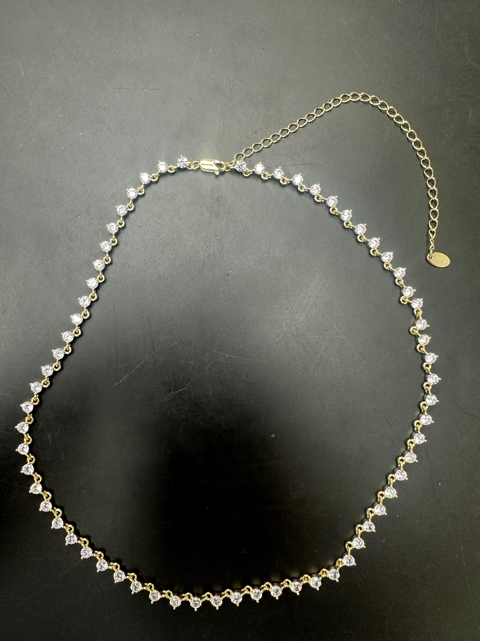 Sterling silver cz stone necklace featuring round 3.0mm cz stones, elegantly gold plated for a luxurious look.