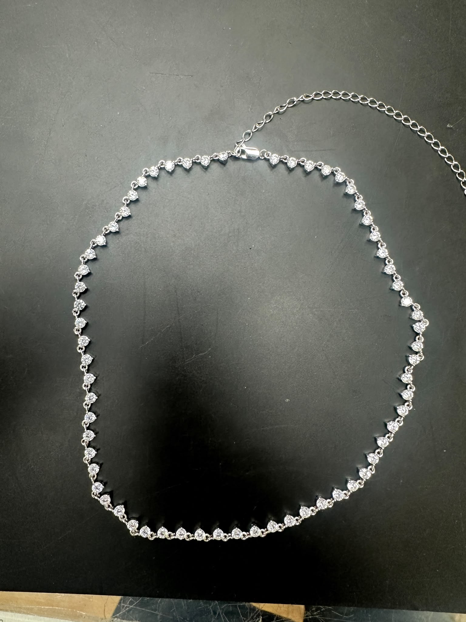 Sterling silver cz stone necklace featuring round 3.0mm stones arranged in a stylish pattern.