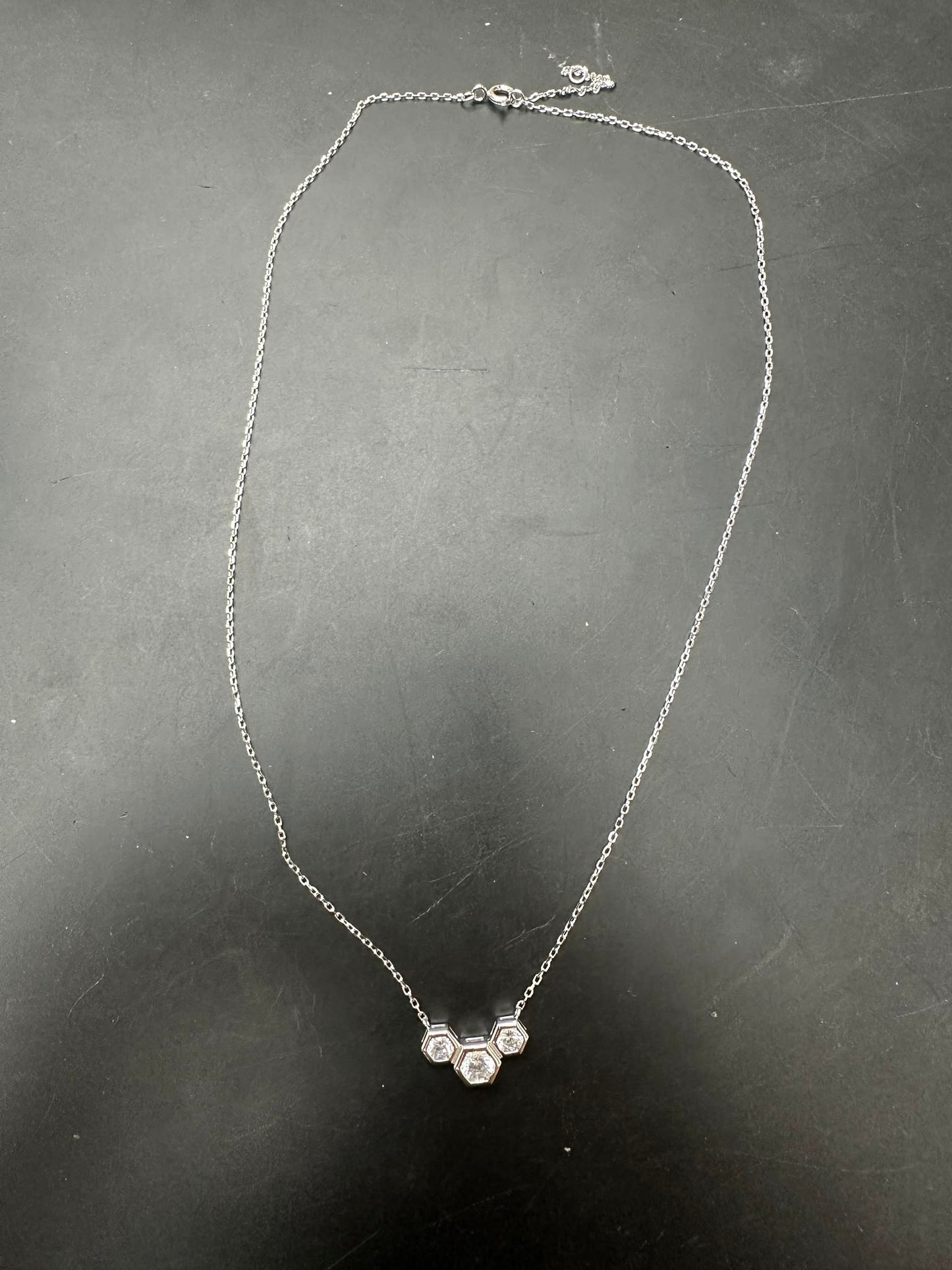 Sterling silver cz stone necklace featuring a unique design with three sparkling stones, 4.0mm and 5.0mm details.
