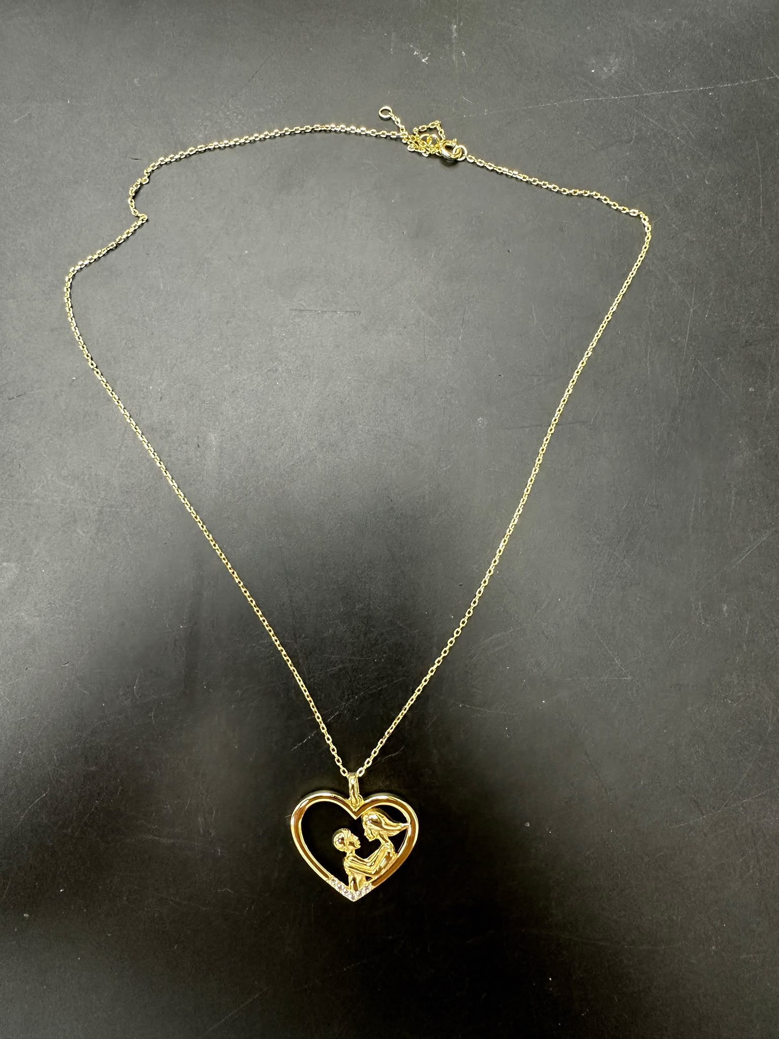 Sterling silver mother child necklace in gold plated heart design, ideal for gifts and special occasions.