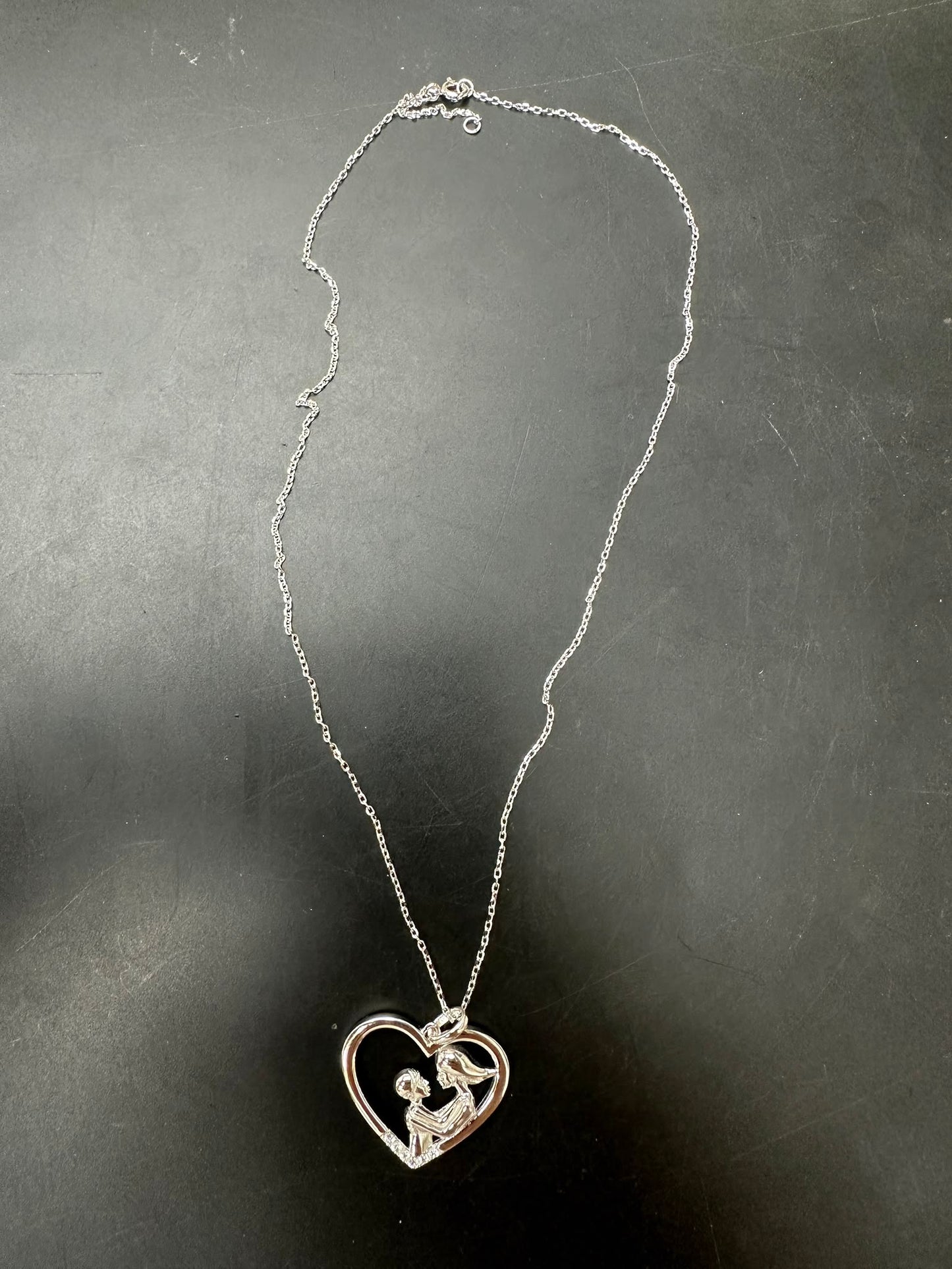 Sterling silver mother child necklace with heart design and chain, showcasing love and connection.