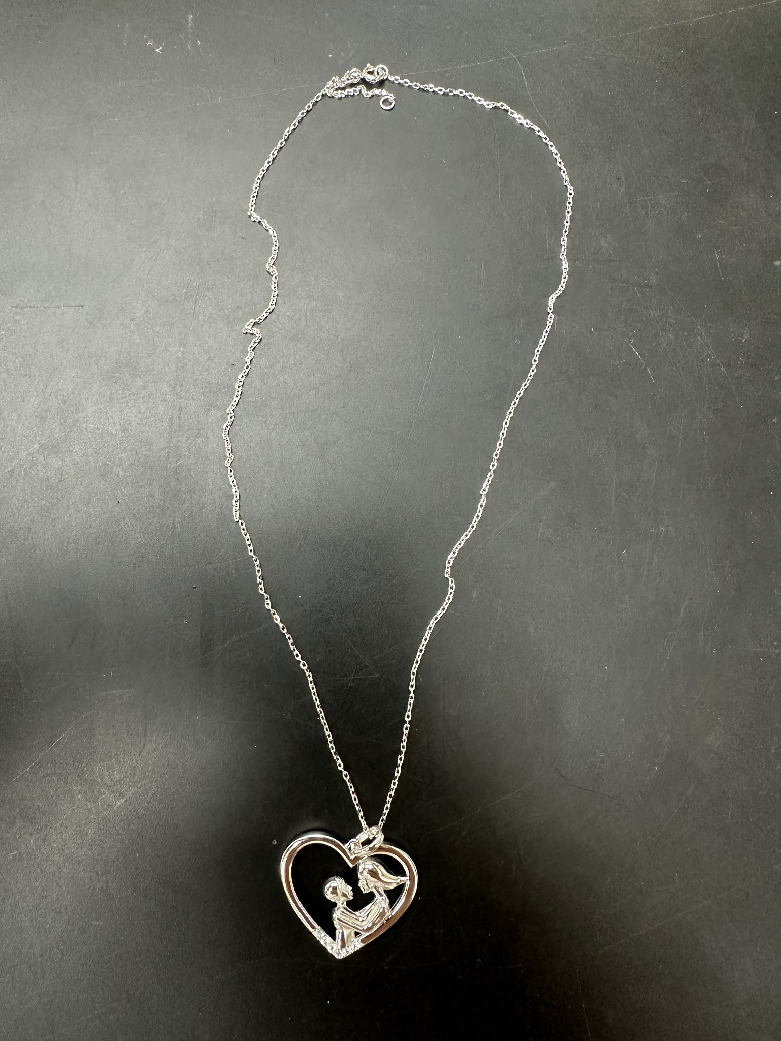 Sterling silver mother child necklace with heart design and chain, showcasing love and connection.