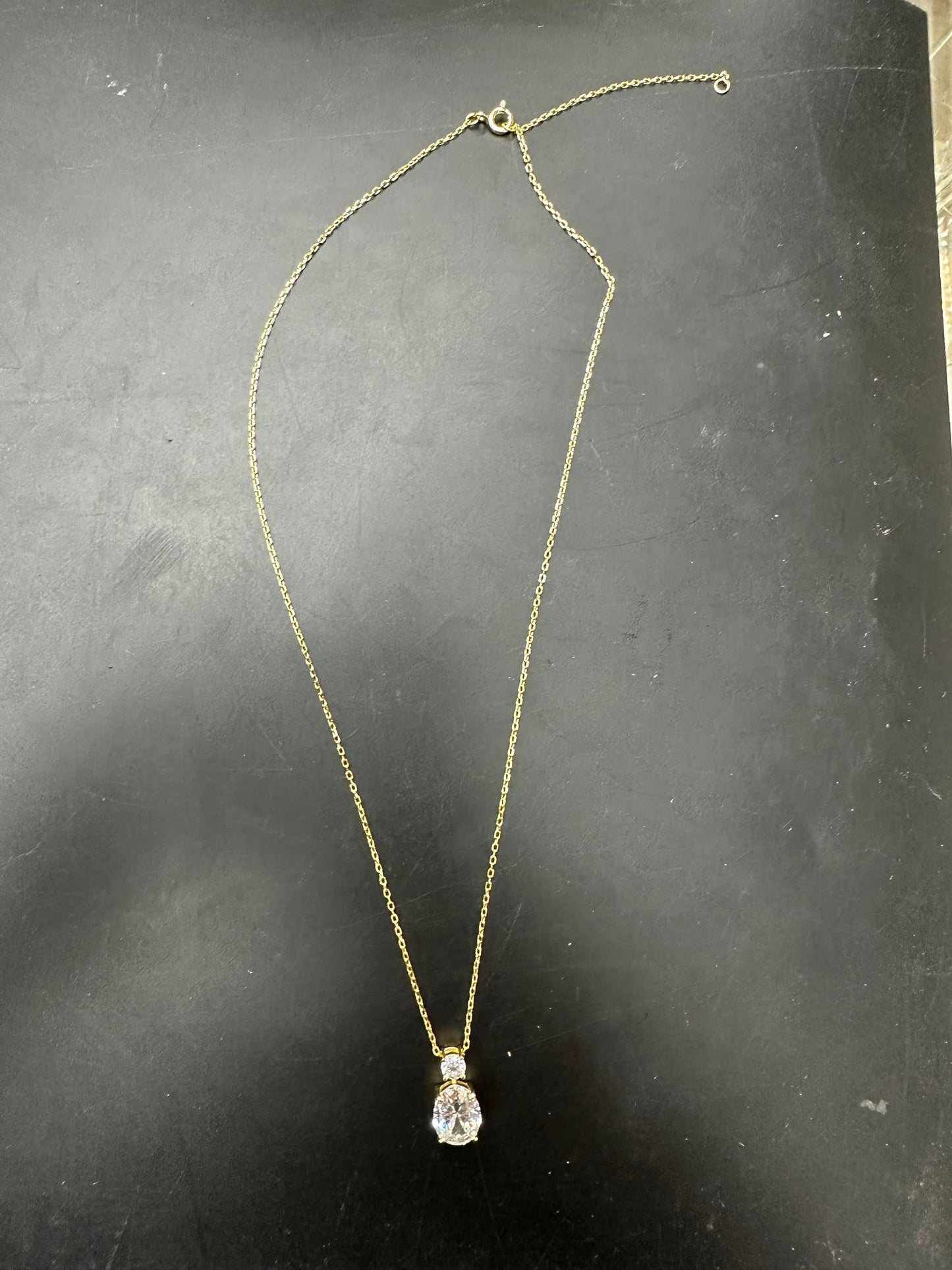 Sterling silver oval necklace with an 8x10mm oval stone, gold plated chain, and a round 3.5mm stone accent.