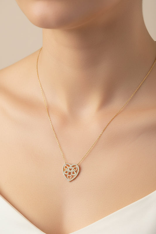 Sterling silver heart shaped necklace worn elegantly against a woman's skin, showcasing its intricate design.