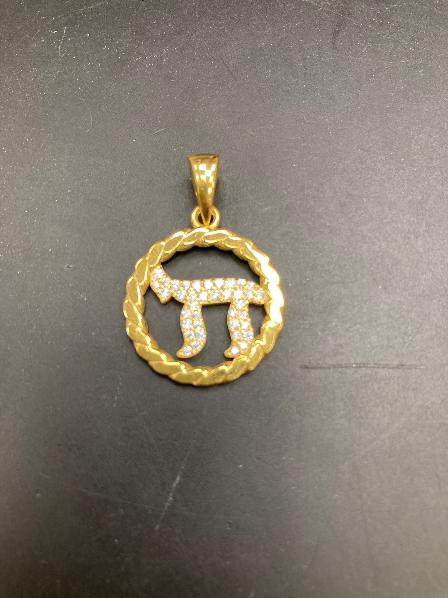 Sterling silver Hebrew chai pendant featuring a unique gold design with sparkling details.