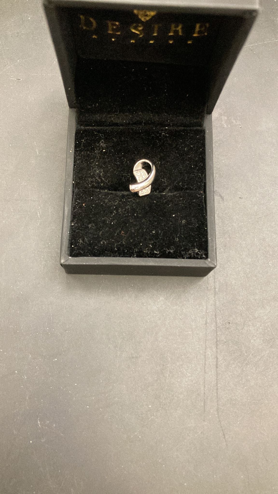 Sterling Silver Curved Cz Pendant PCZ016 displayed in a jewelry box with a black velvet interior.