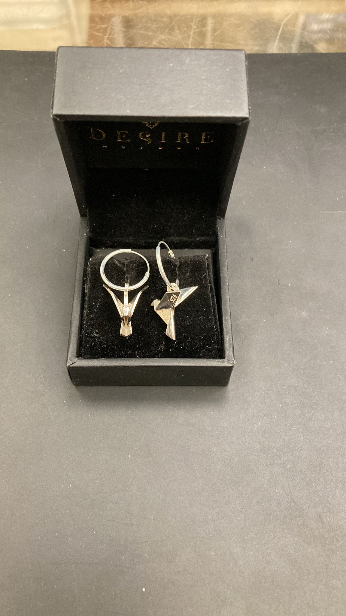 Sterling silver origami earrings displayed in a black jewelry box.