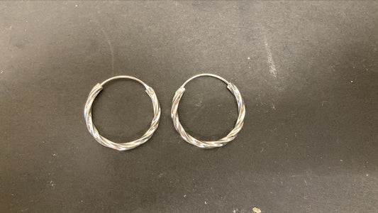Sterling Silver Twist Hoop Earrings PE011590025 showcased on a dark surface.
