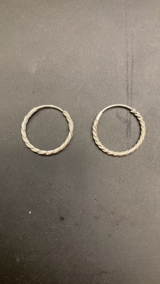 Sterling Silver Twist Hoop Earrings PE011670013 displayed on a dark background.