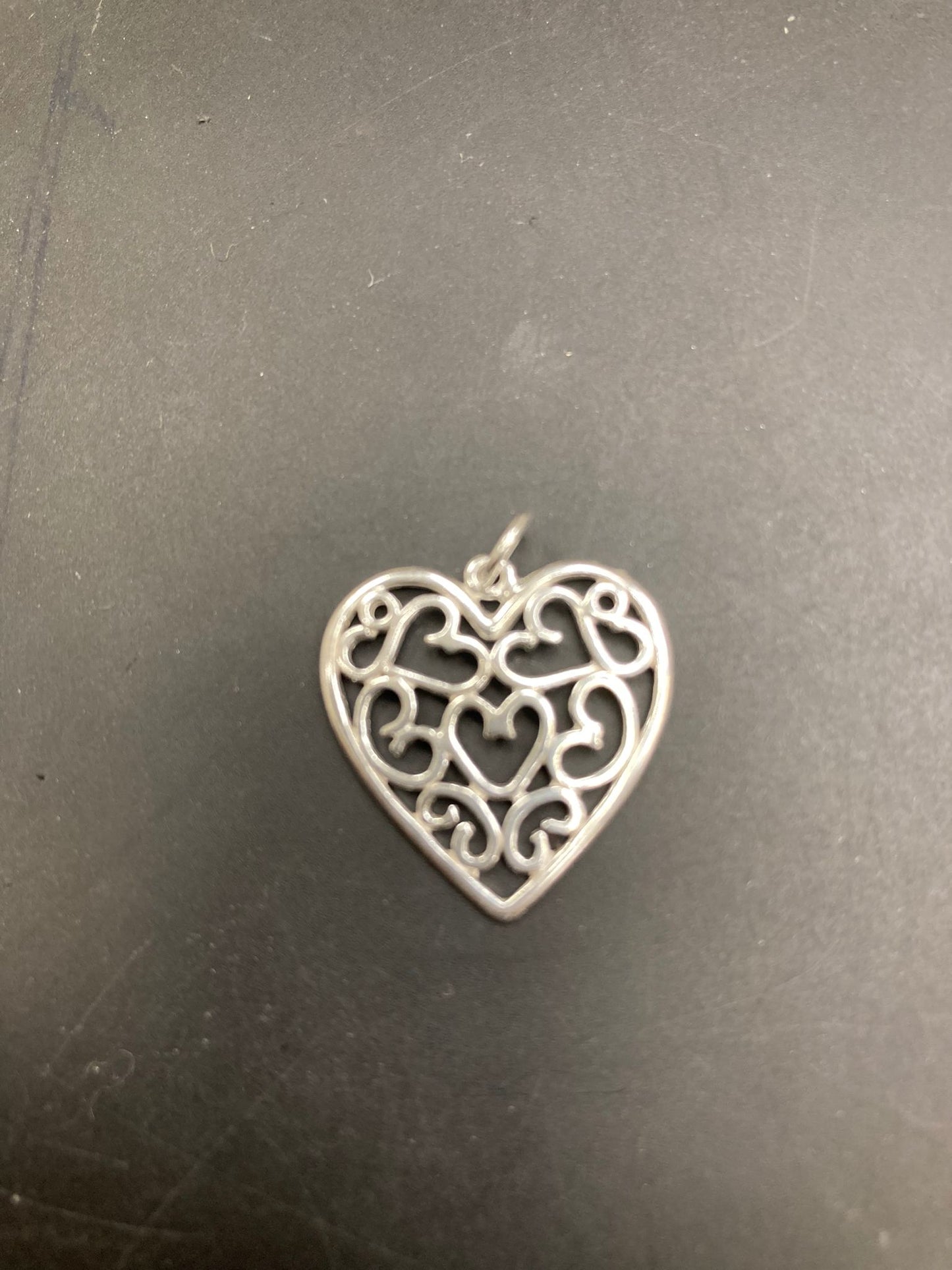 Sterling silver filigree heart pendant PP012 showcasing intricate heart designs and elegant craftsmanship.