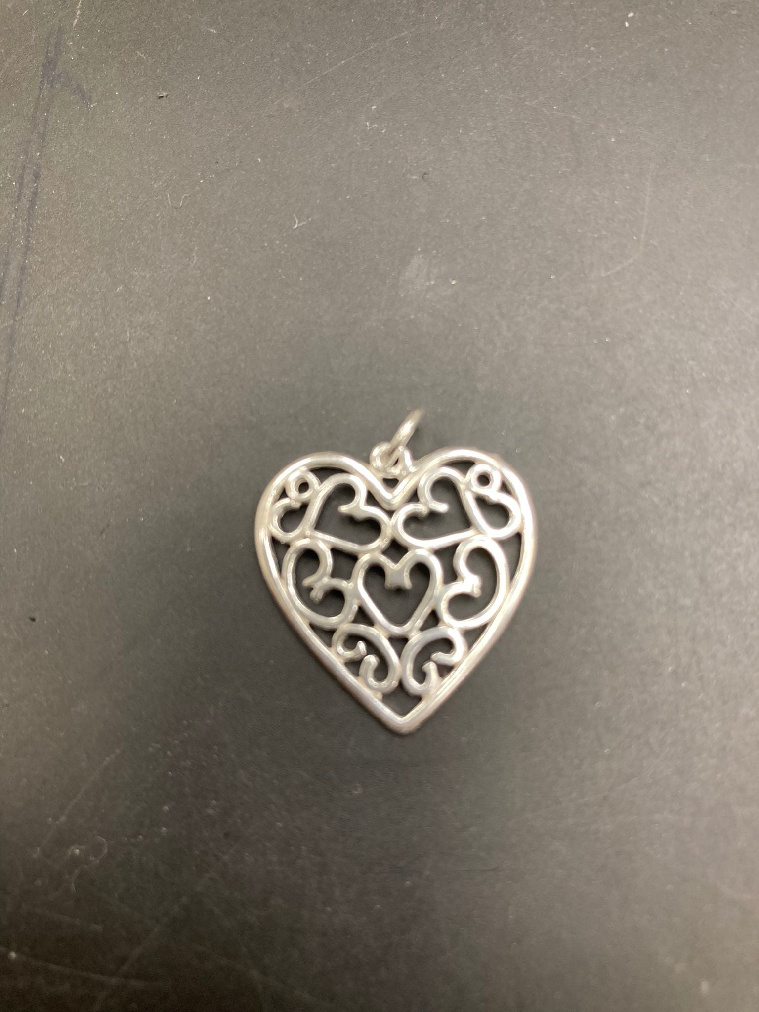 Sterling silver filigree heart pendant PP012 showcasing intricate heart designs and elegant craftsmanship.