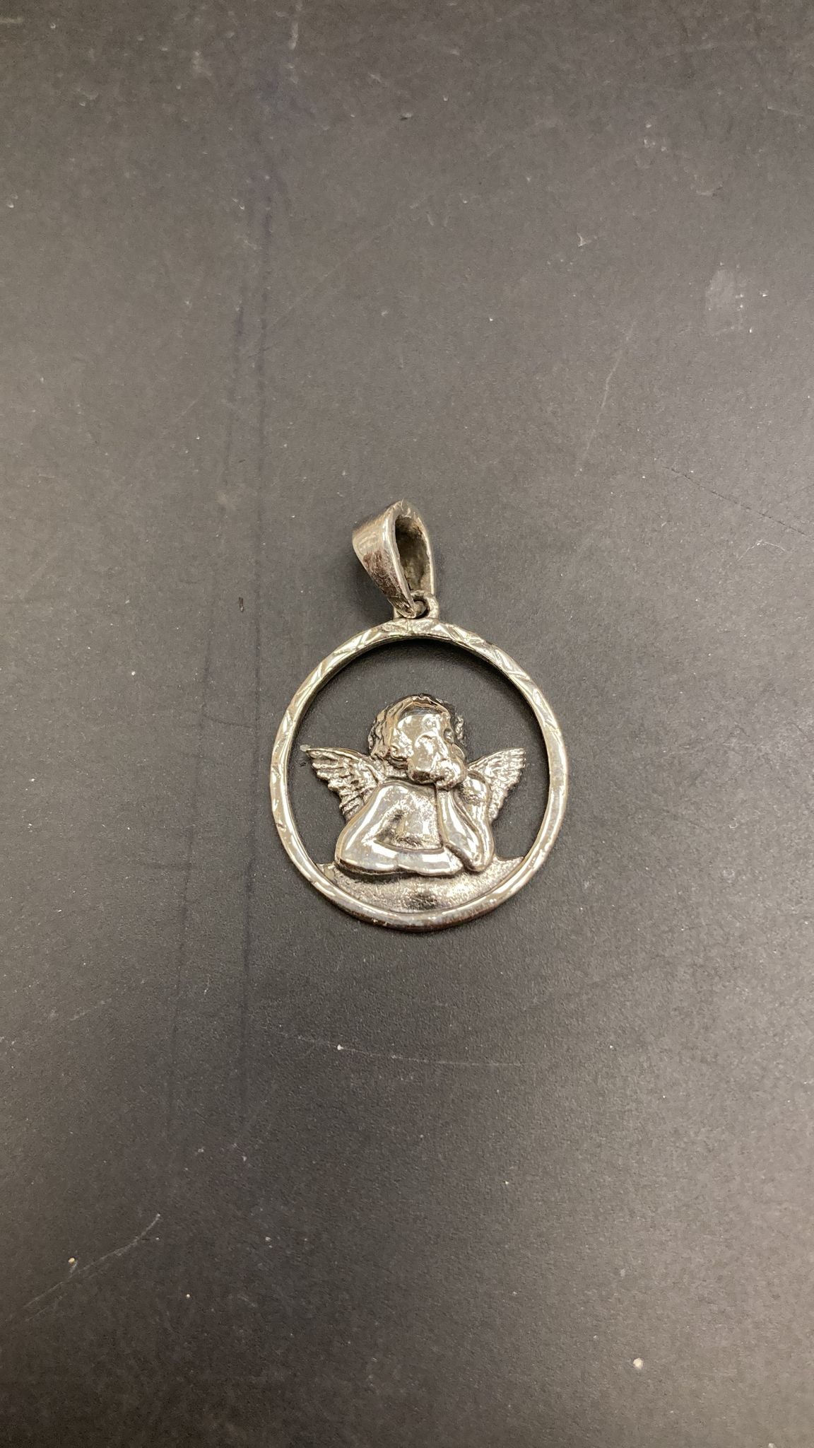 Sterling Silver Angel Pendant PP021270175 featuring an angel in a circular design, showcasing intricate details.