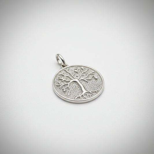 Sterling silver tree of life pendant with intricate tree design and polished finish.
