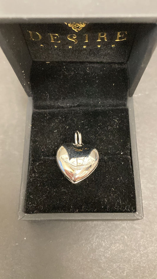Sterling silver heart shape pendant in a black velvet box with the word DESIRE.