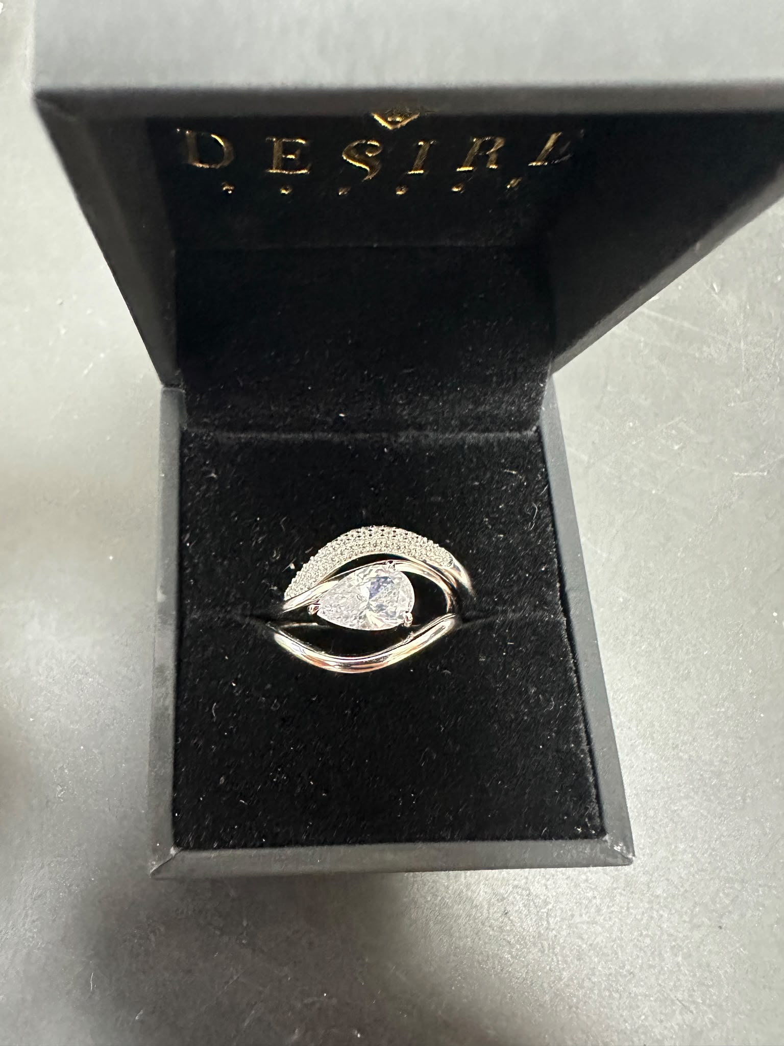 Sterling silver triple ring cz stone in elegant box with round cz stone center.