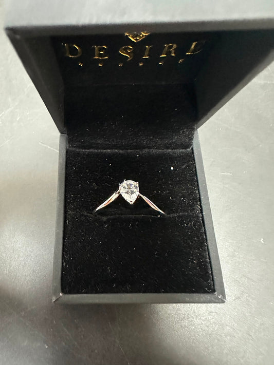 pear cut sterling silver ring with cz stone in a black jewelry box.