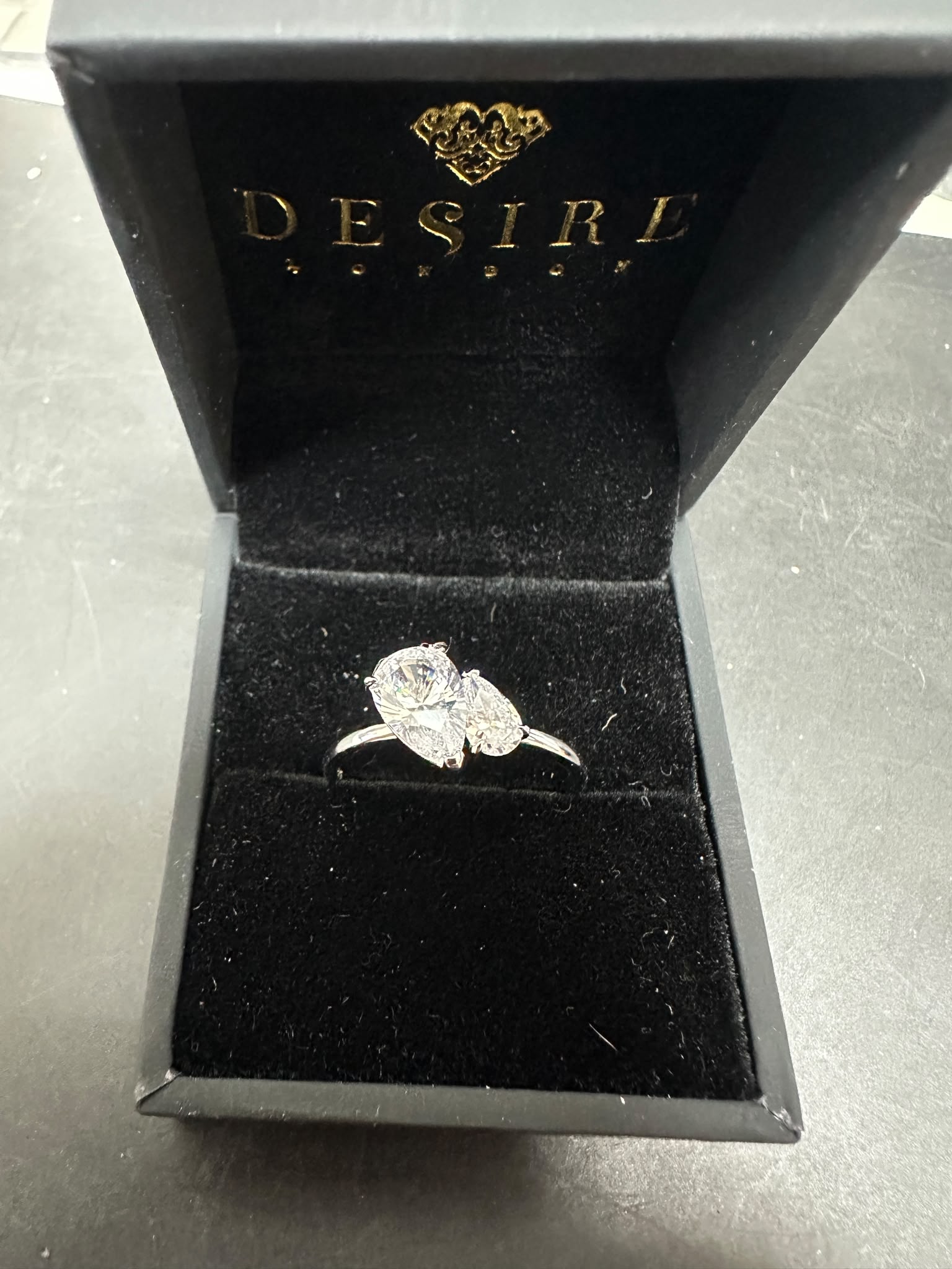 Sterling silver two pear stone ring featuring CZ stones in a desire jewelry box.