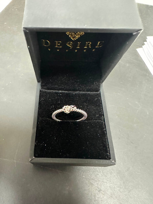 Sterling silver twisted ring displayed in an elegant Desire jewelry box, showcasing its unique design.