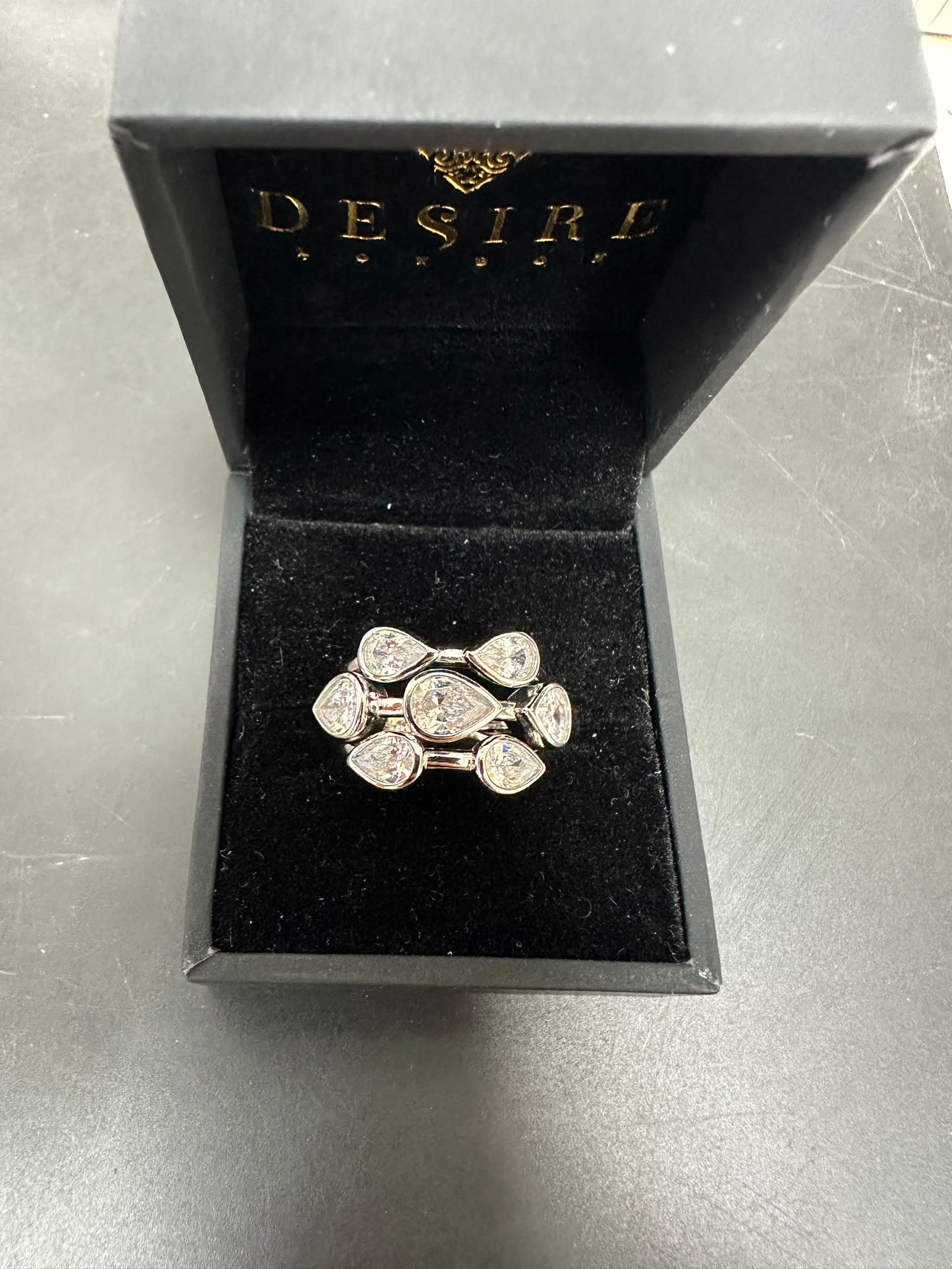 Sterling Silver Bubble Ring Cz Stone displayed in a Desire jewelry box with a black velvet interior.