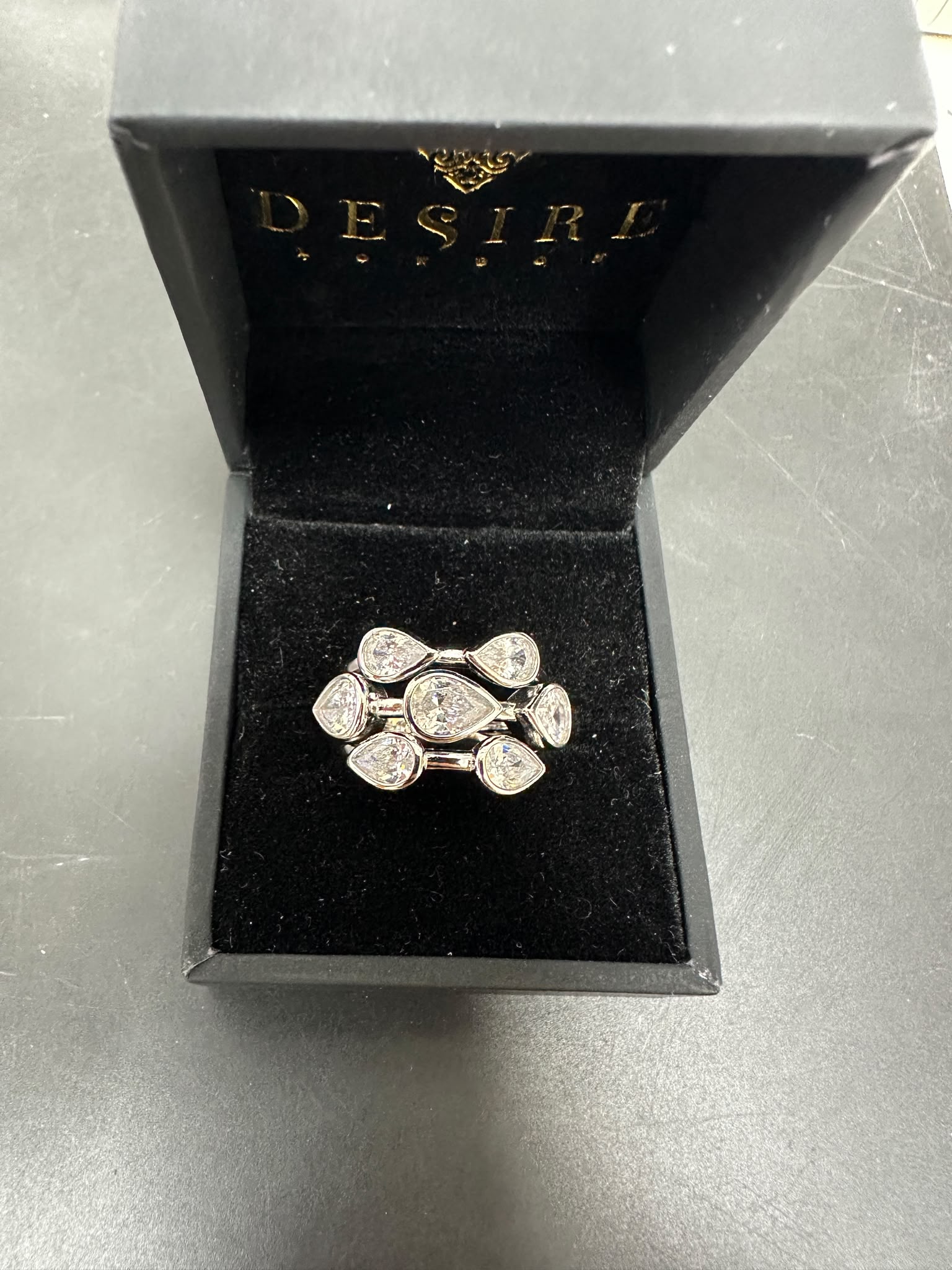 Sterling Silver Bubble Ring Cz Stone displayed in a Desire jewelry box with a black velvet interior.