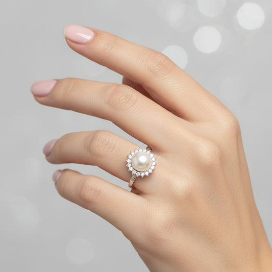 Sterling Silver Cz Pearl Ring RCZ1301 displayed on a hand with a blurred sparkling background.