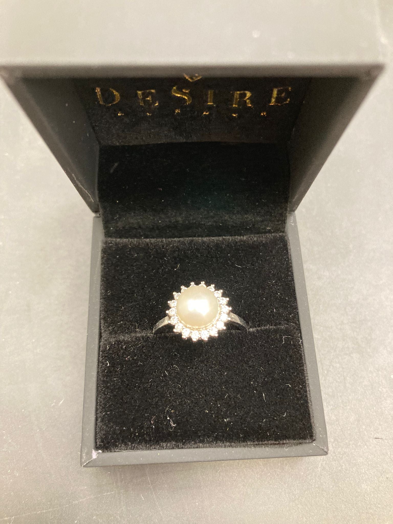 Sterling Silver Cz Pearl Ring RCZ1301 displayed in a stylish black jewelry box with velvet lining.